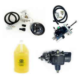 A collection of components for a complete steering package, including a power steering pump, gearbox, hydroboost unit, and a bottle of steering fluid.